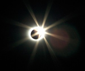 The "diamond ring" as the sun peeks through a valley on the moon, while the corona is still visible.